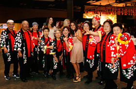 Friendships are made at the Friendship Gala. Aichi Prefecture's Obu Hana Matsuri/Obanakai members pose with Miss Kona Coffee for a photograph.