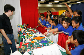 The children are amazed at the origami creations made from a single piece of paper.