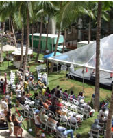 Performance stage located in Waikiki Beach Walk is filled with Hawaiian vibe, palm trees and the blue sky.