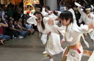 The performers dancing energetically right in front of the spectators, so close that you can hear them breathing