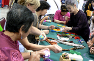 Making temari, considering the color combination and winding the thread to make the ball.