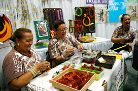 The ladies demonstrate how to make Hawaii feather leis, a tradition that has been preserved since the days of Hawaiian royalty.