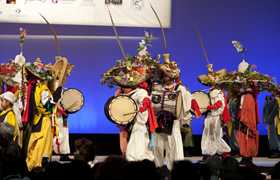 Colorful costumes and a variety of musical  instruments create a dramatic stage presentation.