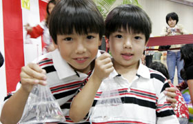 These brothers came to the goldfish scooping booth with their mom who is originally from Japan. They were happy to scoop up so many goldfish.