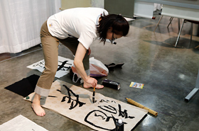 A calligraphy demonstration. Her smooth technique stopped spectators in their tracks to watch.