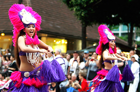 Members of Anela. Hula Studio. Their colorful costumes and rhythmical dancing made the rain disappear.