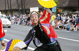 The dancers of Miyagi University Kosuzume use their folding fans. Such colorful costumes!