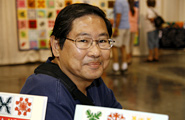 Gordon Chun and his original free-hand taro design quilt.
