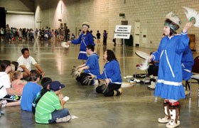 The students pay attention and learn a Native Alaskan dance.