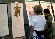 Attendees read each panel of the Joseph Heco exhibit