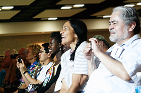 The audience cheers and smiles for the performers.