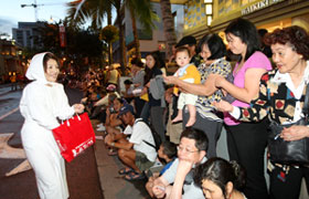 The Ama lady shell divers of Toba-City pass out packets of pearls to the spectators at the parade to promote their port city. The crowds love it!