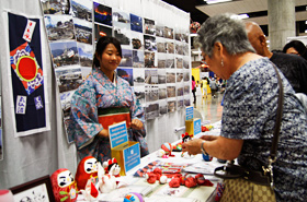 People donate funds, no matter how little, to support Tohoku's rebuilding efforts.