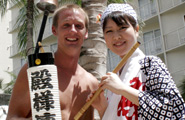 A Tonosama Ren awaodori dancer poses for a picture with a spectator. An example of friendship and goodwill.